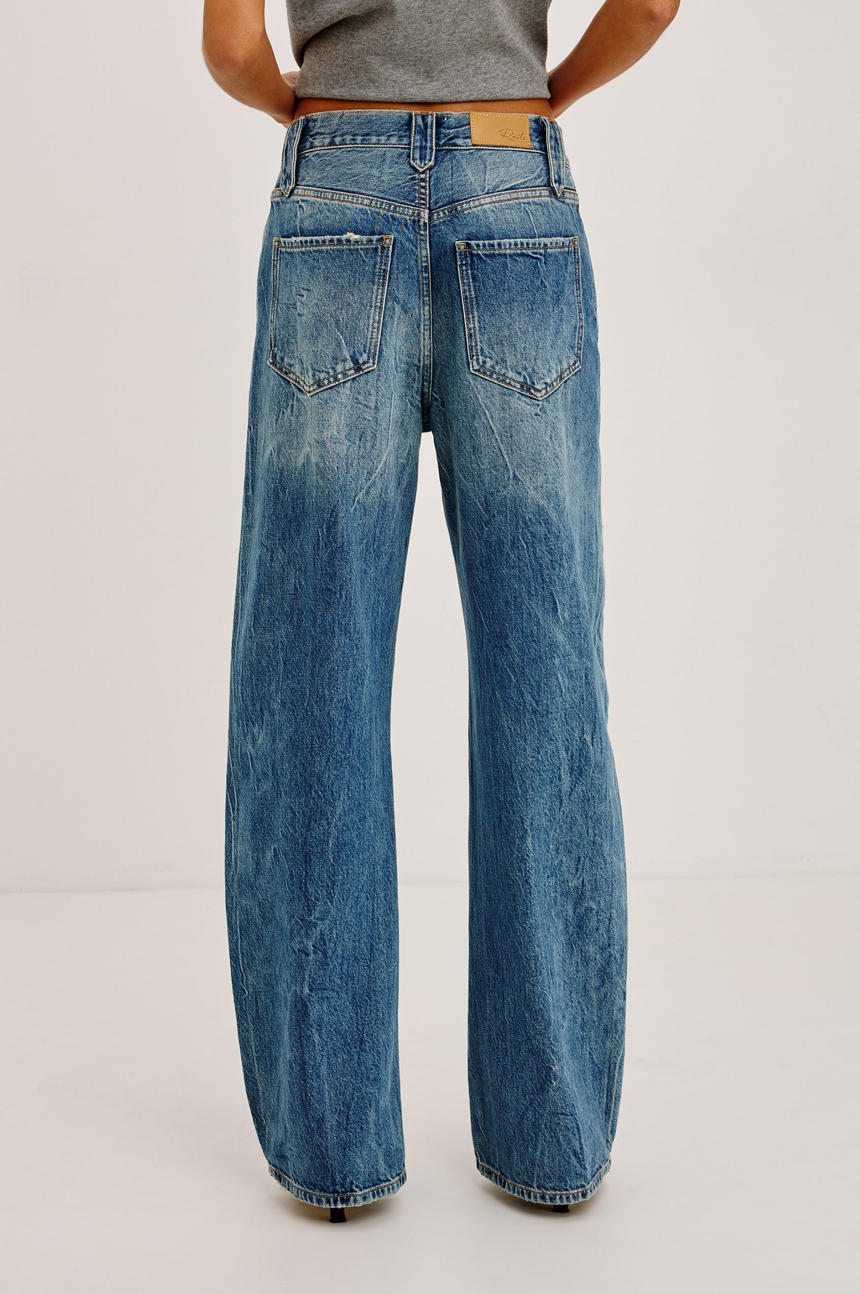Belmont Arc Leg Jean in Rigid Denim With High Rise, Western Side Seam and Stud Detailing, Button Fly, and Side and Back Pockets in Night Cap Colorway - Lower Body Back View Featured on Model