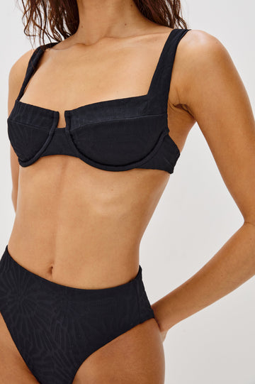 Bianca Underwire Top with Fixed Straps, 3-Point Adjustable Clip Back, U Front, Paneled Cup, Fossils Texture in Black Colorway. Front Detailed View Shown on Model.