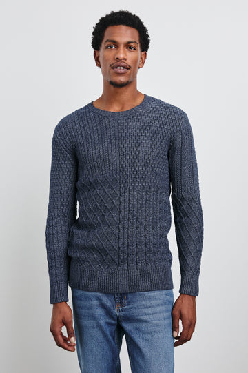 Biarritz Long-Sleeve Sweater with a Crew Neck and Patches of Different Cable Knits in Multi Weave Indigo Colorway - Front View Featured on Model 