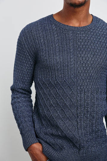 Biarritz Long-Sleeve Sweater with a Crew Neck and Patches of Different Cable Knits in Multi Weave Indigo Colorway - Front View Featured on Model 