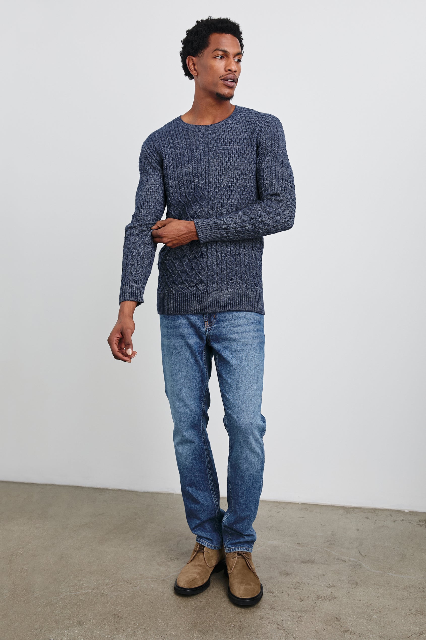 Biarritz Long-Sleeve Sweater with a Crew Neck and Patches of Different Cable Knits in Multi Weave Indigo Colorway - Front Full Body View Featured on Model 