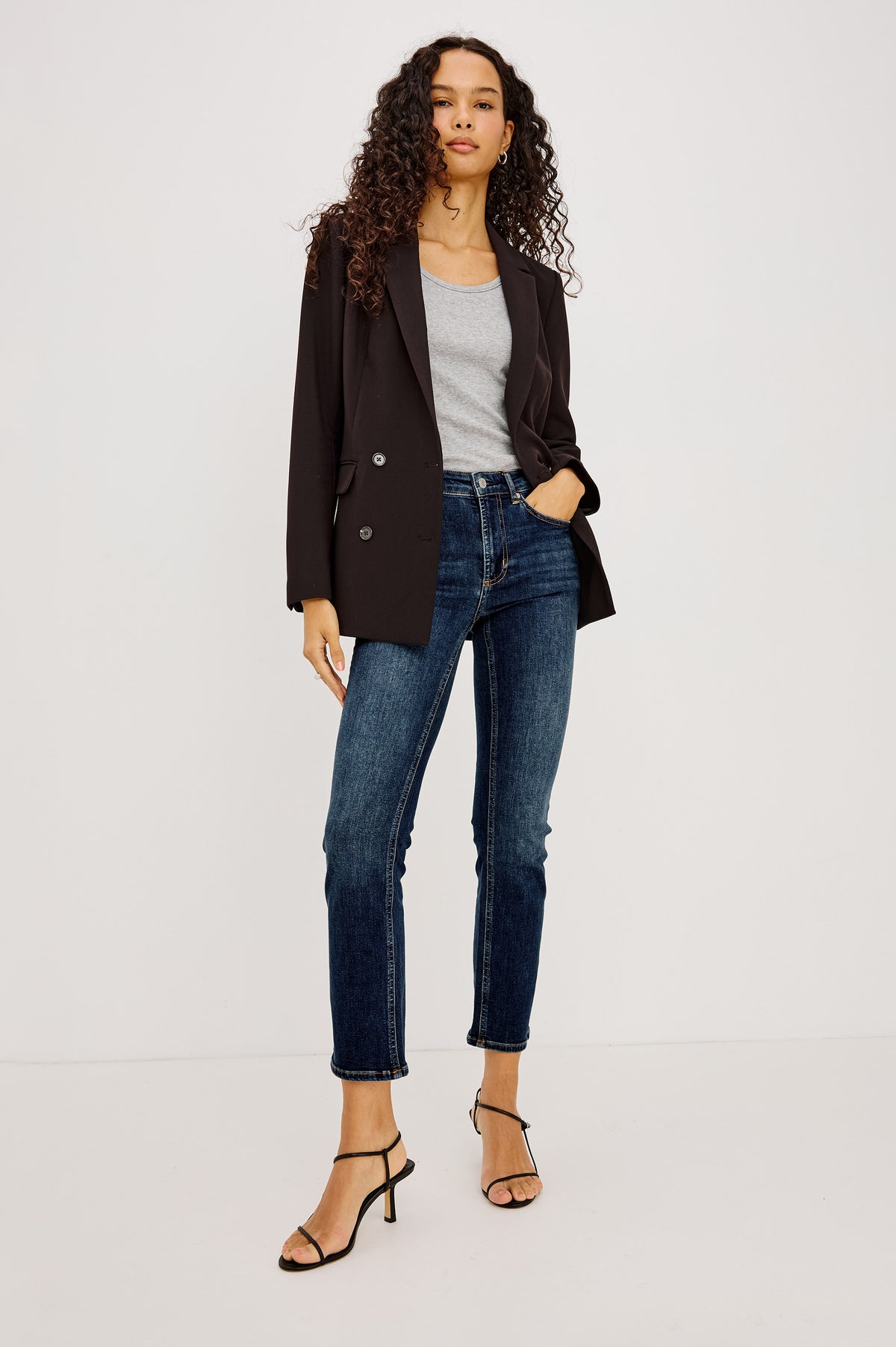 Bixby Mid-Rise Slim Straight Jean in High Stretch Denim With 25" Inseam, Zip Fly, and 5-Pockets in Deep Dive Colorway - Full Body Front View Featured on Model Sitting