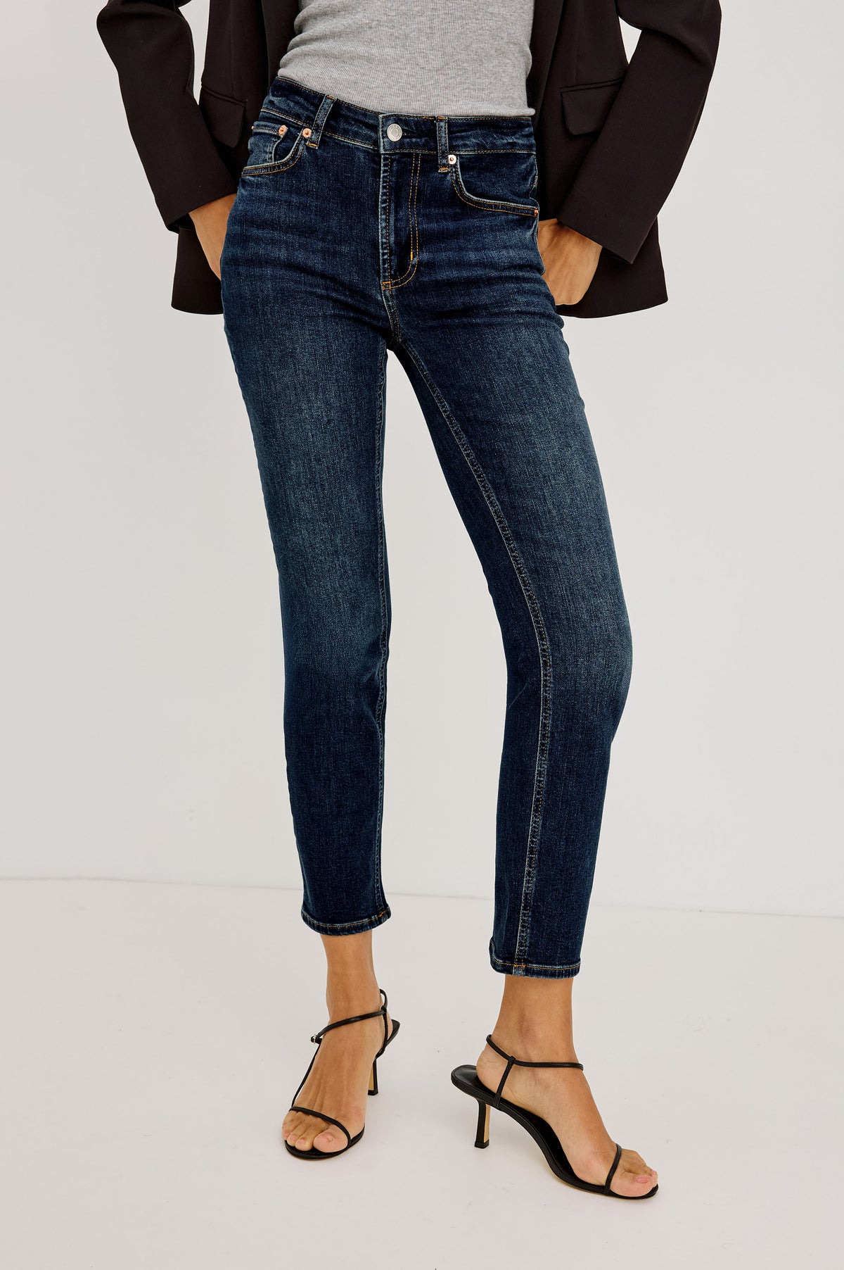 Bixby Mid-Rise Slim Straight Jean in High Stretch Denim With 25″ Inseam, Zip Fly, and 5-Pockets in Deep Dive Colorway - Lower Body Front View Featured on Model