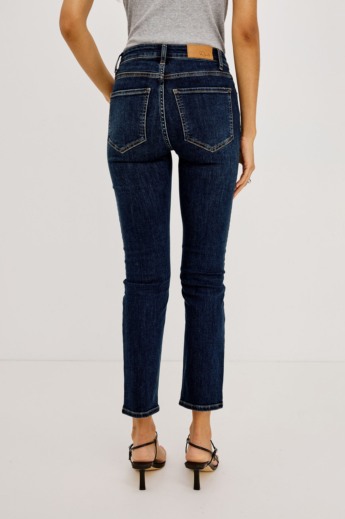 Bixby Mid-Rise Slim Straight Jean in High Stretch Denim With 25" Inseam, Zip Fly, and 5-Pockets in Dive Colorway - Lower Body Front View Featured on Model