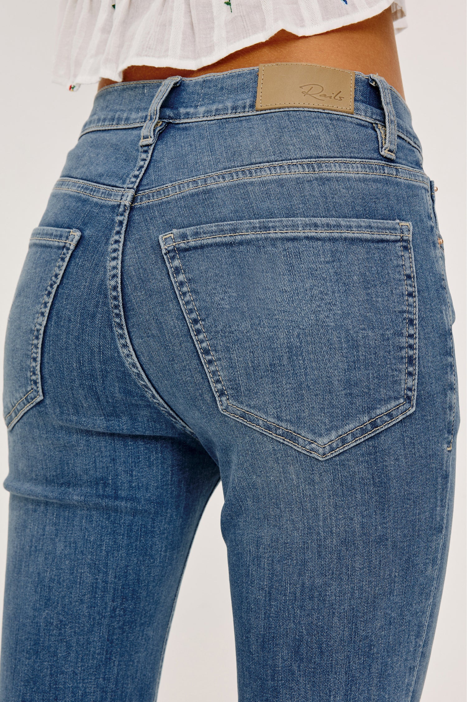Bixby Mid-Rise Slim Straight Jean in High Stretch Denim With 25″ Inseam, Zip Fly, and 5-Pockets in East Coast Colorway - Lower Body Back View Featured on Model