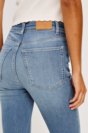 Bixby is a 5-pkt slim straight jean in Vista Blue colorway. Close up back view featured on model.