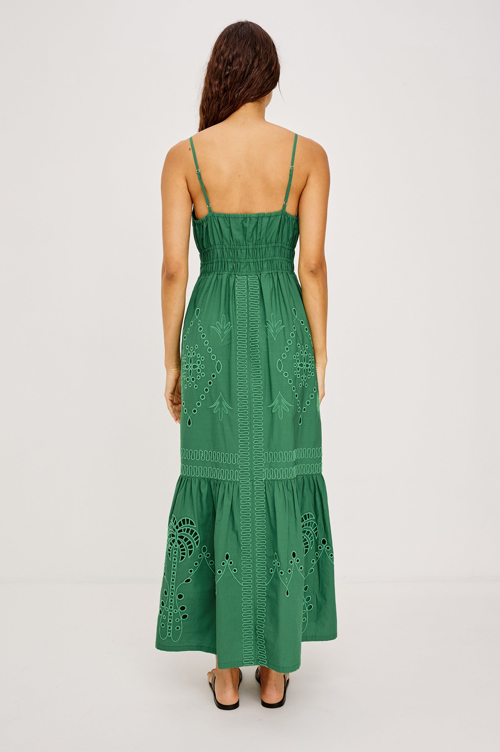 Blair Maxi Dress in Cotton Poplin With V-Neckline, Adjustable Spaghetti Straps, Elastic Waist Paneling, Soutache Tropical Embroidery, Back Smocking, Adjustable Shoulder Straps, and is Fully Lined in Clover Colorway - Full Body Back View Featured on Model