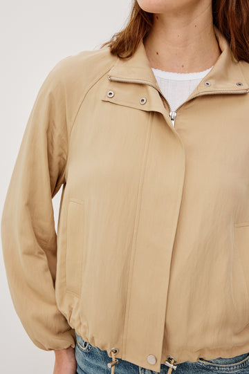 Blake Oversized Cropped Jacket With High Funnel Neck Double-Button Closures Long Drop Shoulder Sleeves With Elastic Cuffs Side Pockets and Drawstring Hem in Almond Colorway - Upper Body Close Up View Featured on Model