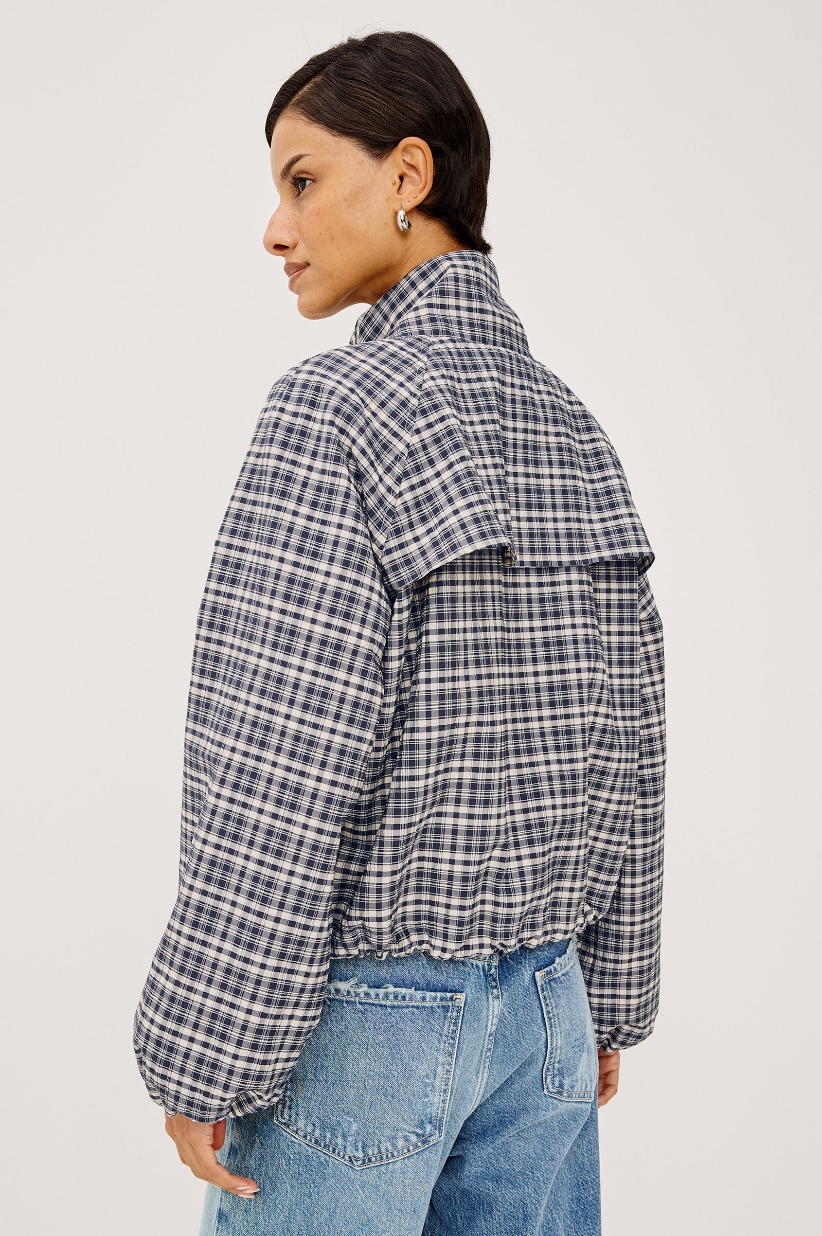 Blake Jacket in Crinkle Nylon Blend With Relaxed Fit, High Funnel Neck, Double Button Closures, Drop Shoulder Sleeves With Elastic Cuffs, and Cropped Drawstring Hem in Mini Check Colorway - Upper Body Back View Featured on Model