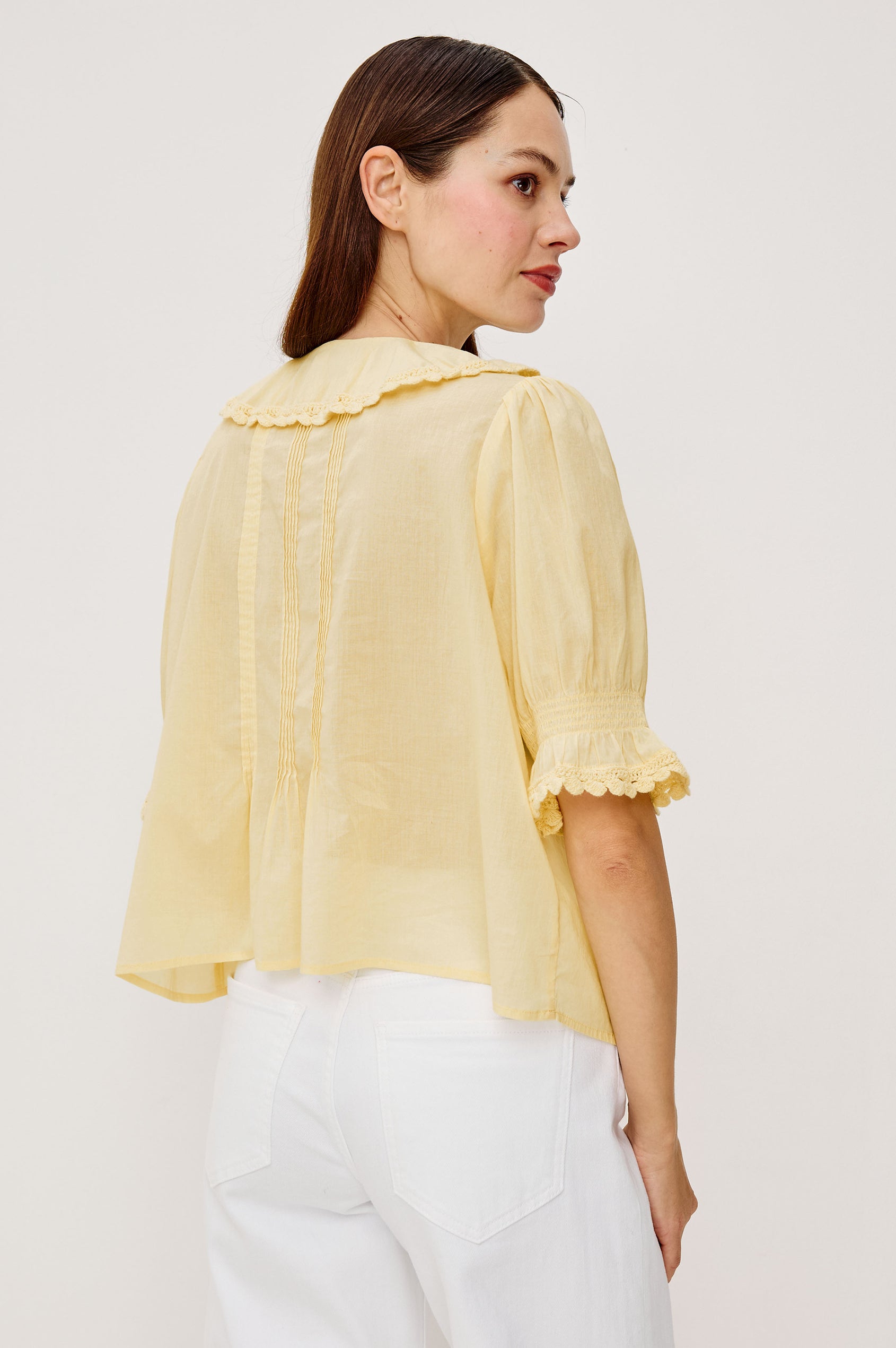 Bloom Poplin Top With Ruffle V-Neckline Elbow-Length Puff Sleeves With Ruffled Cuffs Pintuck Detailing and Boxy Relaxed Fit in Sunshine Colorway - Upper Body Back View Featured on Model