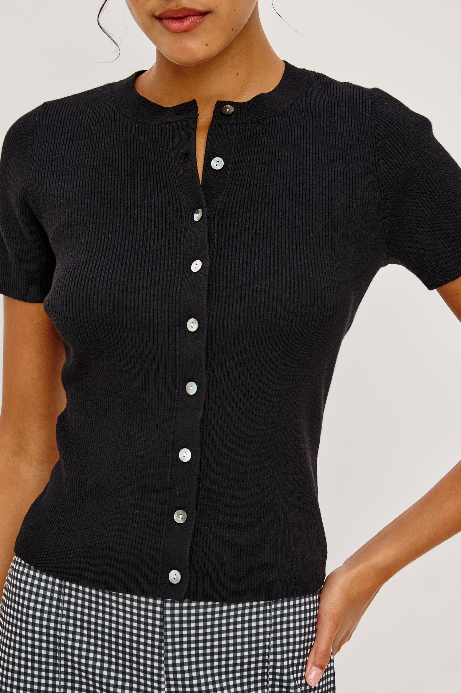 Bonnie Fitted Top in Ribbed Cotton With Crew Neckline Short Sleeves and Front Buttons in Black Colorway - Upper Body Front Close Up View Featured on Model