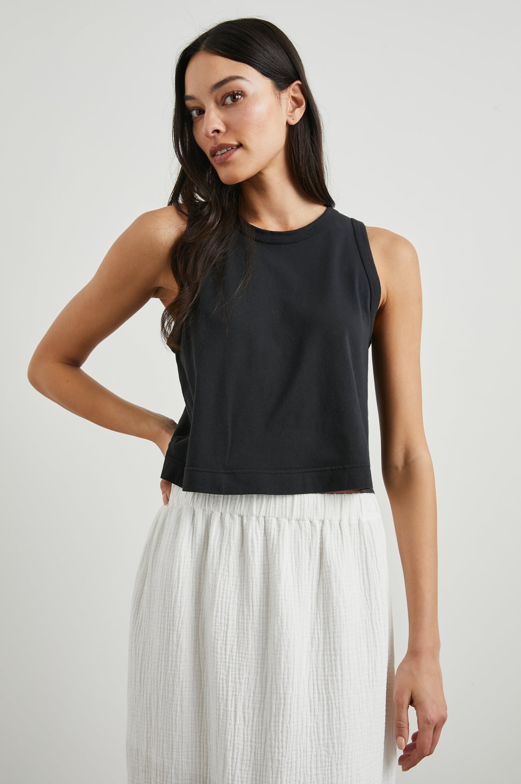 The Boxy Cropped Tank with a Crew Neck in Black Colorway - Front View Featured on Model