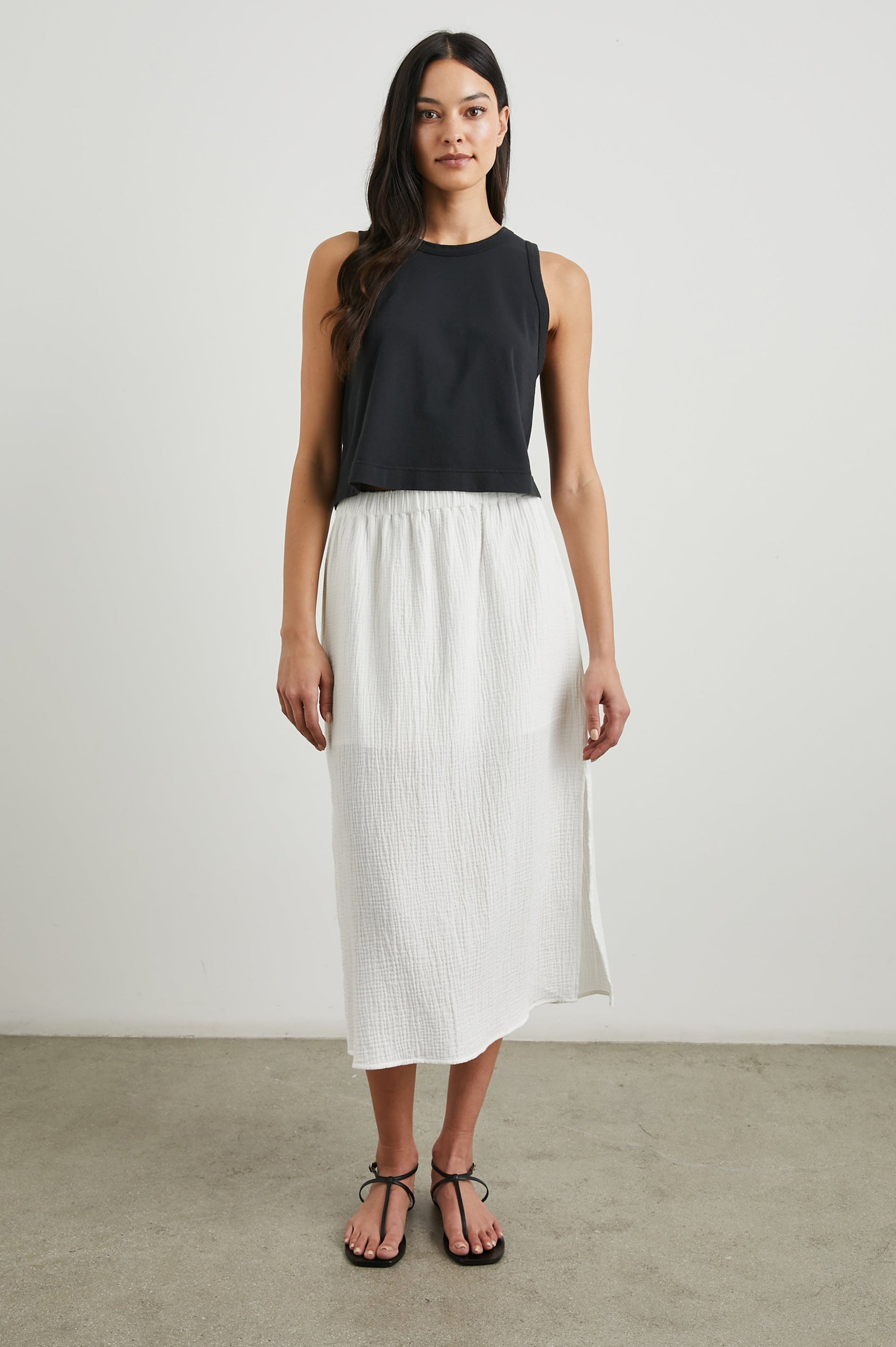 The Boxy Cropped Tank with a Crew Neck in Black Colorway - Front Full Body View Featured on Model