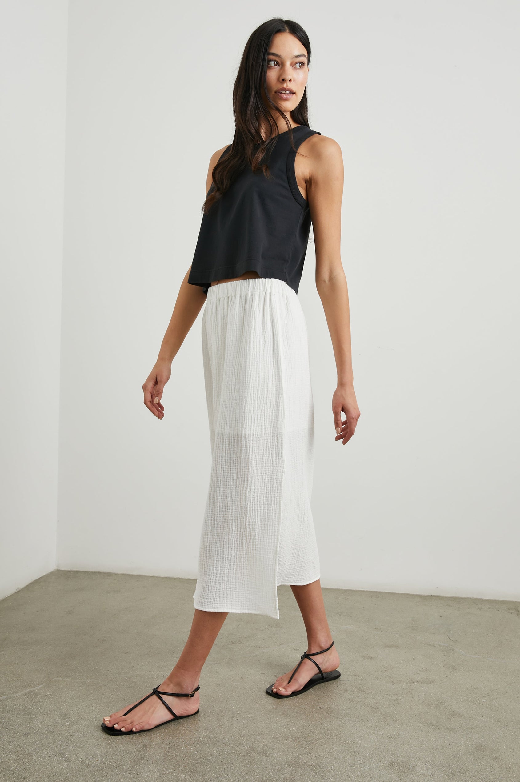The Boxy Cropped Tank with a Crew Neck in Black Colorway - Front Full Body View Featured on Model