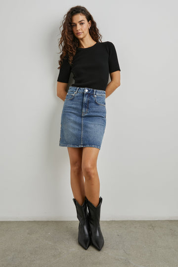 Burbank Denim Mini Skirt with Belt Loops, Two Front Pockets Plus a Coin Pocket and Two Back Patch Pockets in Starry Night Colorway, a Column of Blue Stars on Each Side on Blue - Front Full Body View Featured on Model 