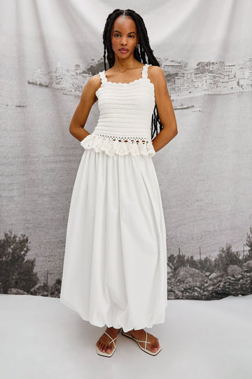 Cala midi length bubble skirt with elastic waistband and side pockets in White Colorway - Stylized full body front view on model.