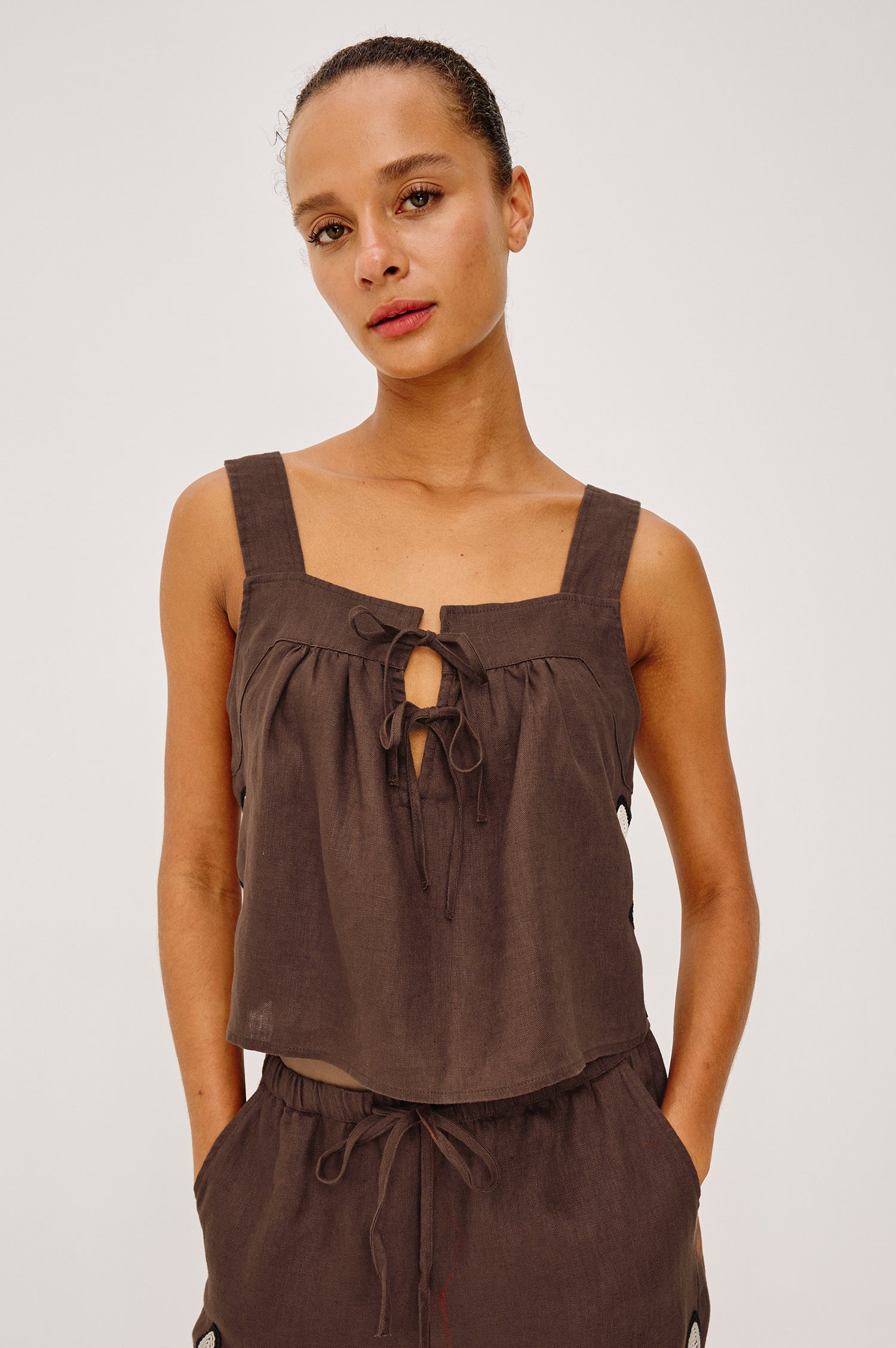 Calais Tank Top in Heavy Linen With Boxy, Loose Relaxed Cropped Fit, Wide Shoulder Straps, and V-Neckline With Adjustable Front Ties in Cocoa Floral Embroidery Colorway - Upper Body Front View Featured on Model