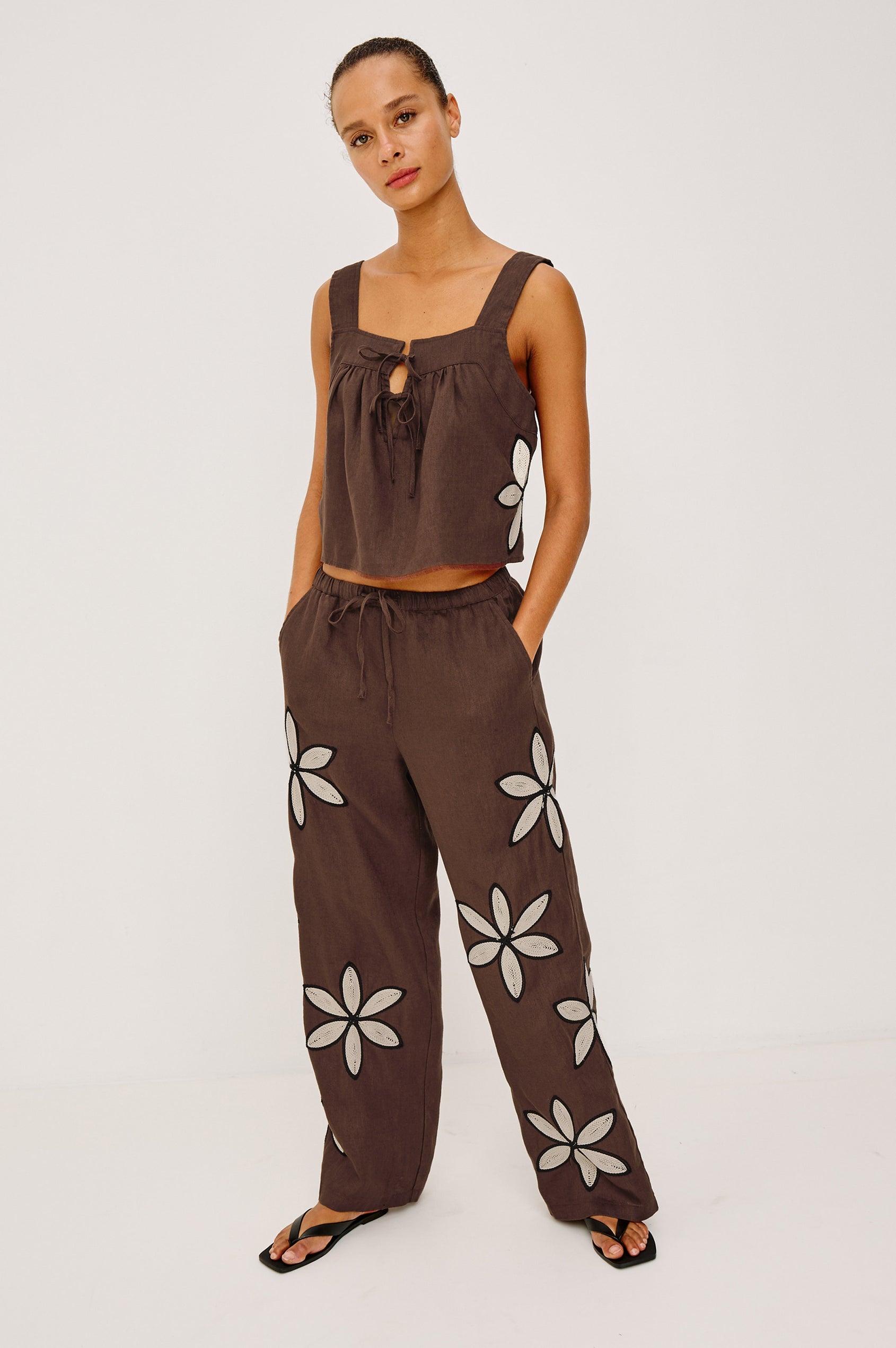 Calais Tank Top in Heavy Linen With Boxy, Loose Relaxed Cropped Fit, Wide Shoulder Straps, and V-Neckline With Adjustable Front Ties in Cocoa Floral Embroidery Colorway - Full Body Front View Featured on Model