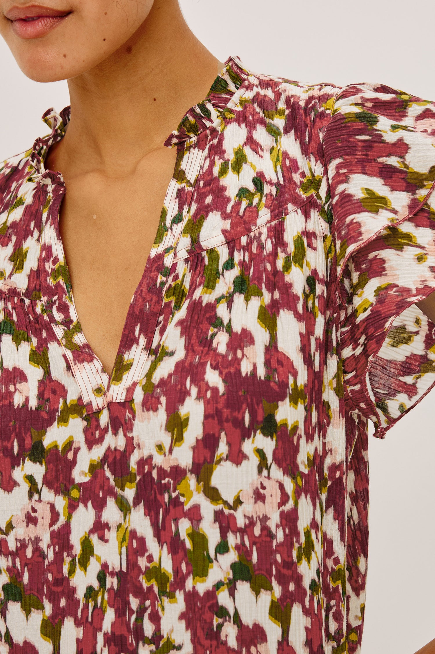 Calista Top in Textured Chiffon With Ruffle Trim Split V-Neckline, Layered Flutter Sleeves, and Relaxed Fit in Cardinal Floral Colorway - Upper Body Front View Featured on Model