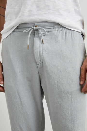Callum Pants with a Drawstring Waist, Two Front Pockets and a Back Patch Pocket in Cement Colorway - Front View Featured on Model