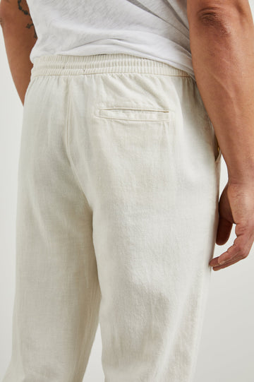 Callum Pants with a Drawstring Waist, Two Front Pockets and a Back Patch Pocket in Ecru Colorway - Back View Featured on Model
