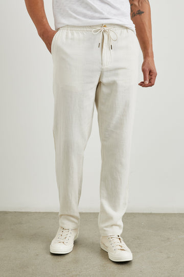 Callum Pants with a Drawstring Waist, Two Front Pockets and a Back Patch Pocket in Ecru Colorway - Front View Featured on Model