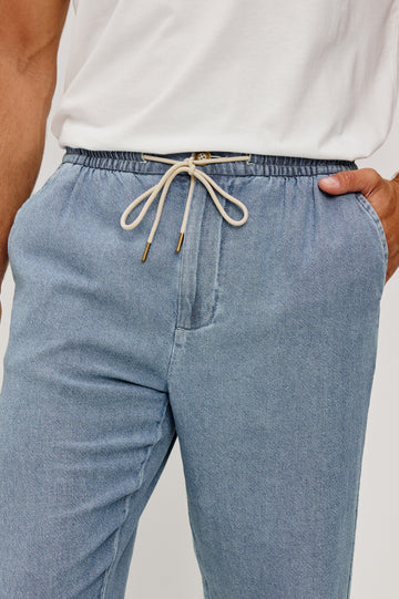 Callum Tapered Straight Leg Pant in Linen Twill With Adjustable Drawstring Waistband Ties in Medium Wash Indigo Colorway - Lower Body Close Up Front View Featured on Model