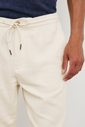 Callum Pants with a Drawstring Waist, Two Front Pockets and a Back Patch Pocket in Ecru Colorway - Front View Featured on Model