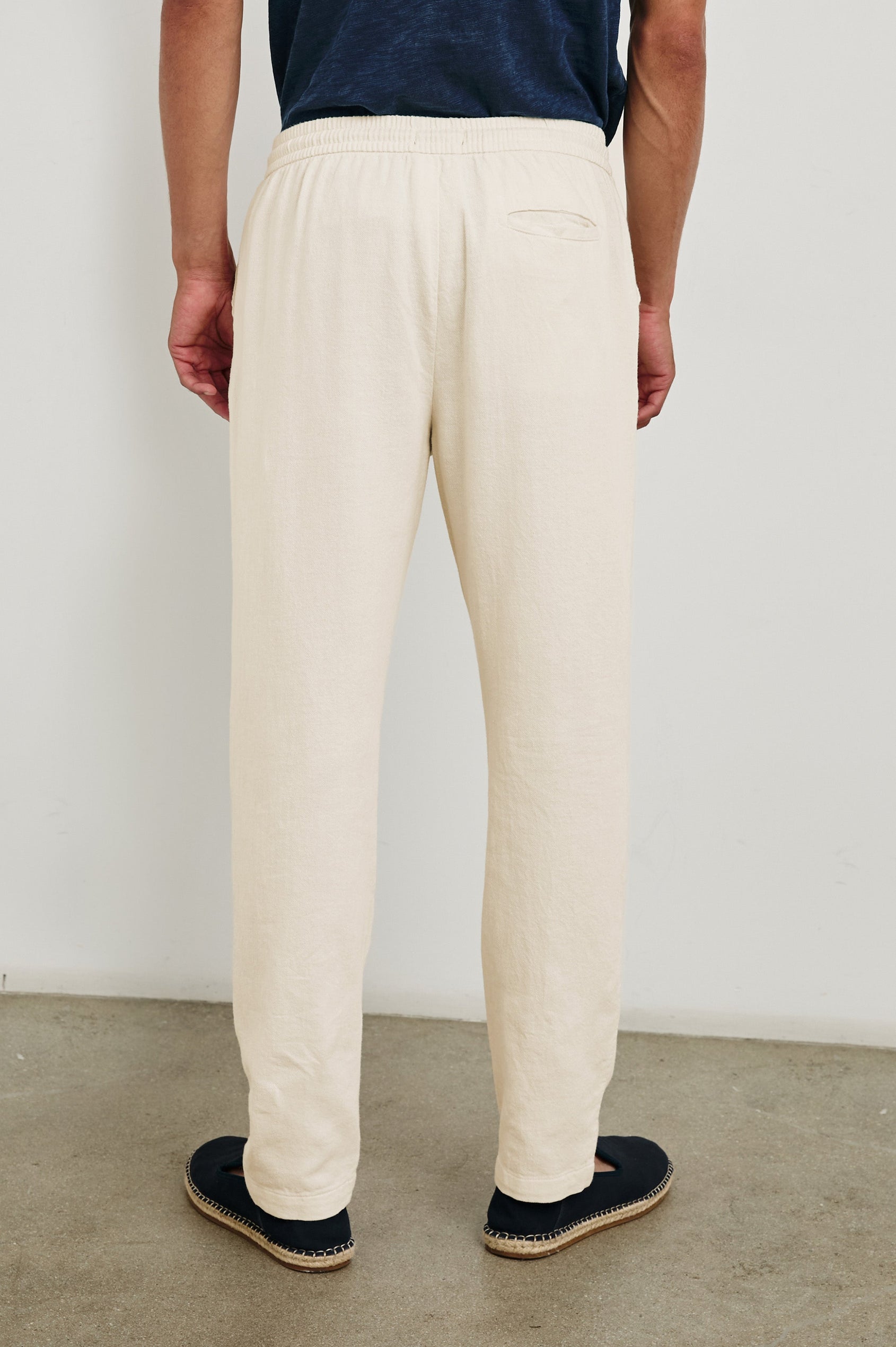 Callum Pants with a Drawstring Waist, Two Front Pockets and a Back Patch Pocket in Ecru Colorway - Back View Featured on Model
