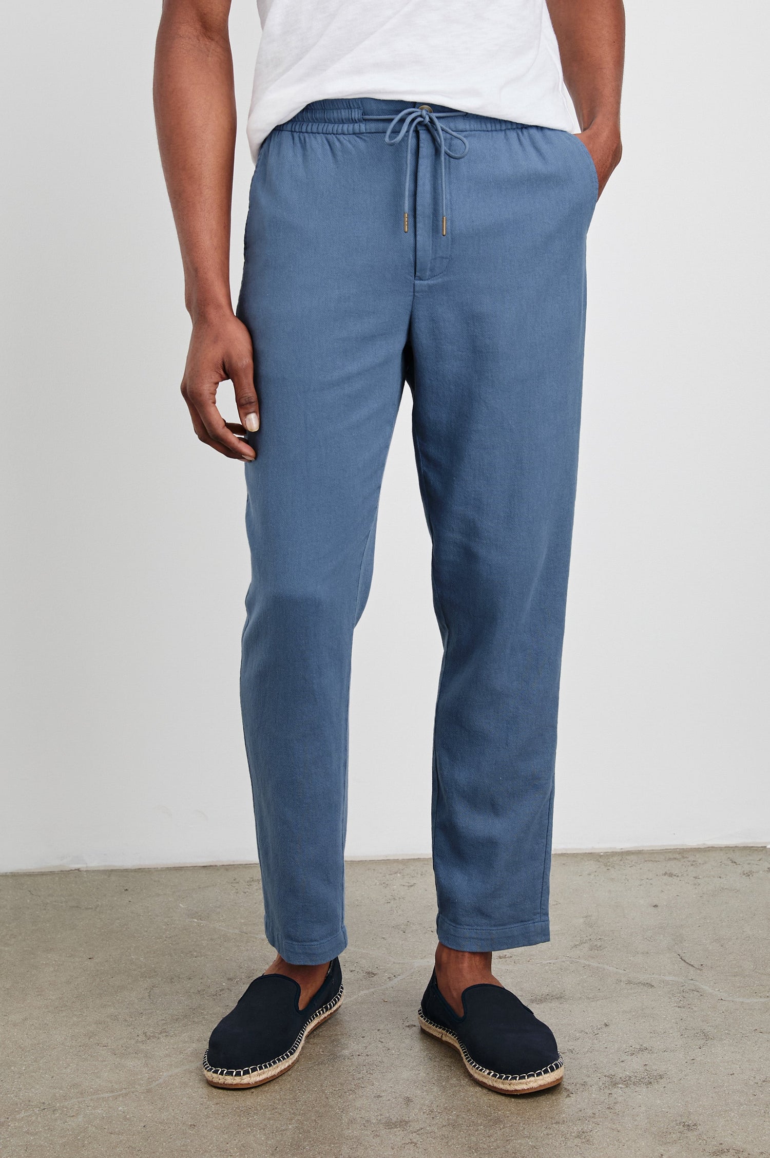 Callum Pants with a Drawstring Waist, Two Front Pockets and a Back Patch Pocket in Washed Blue Colorway - Front View Featured on Model.