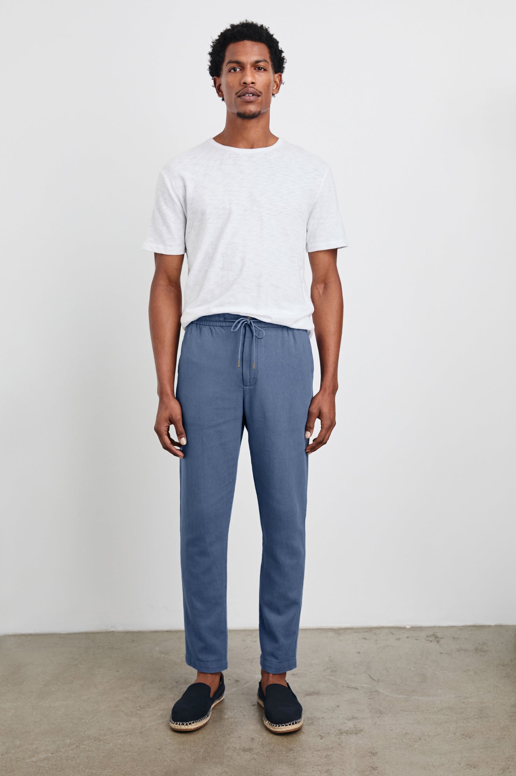 Callum Pants with a Drawstring Waist, Two Front Pockets and a Back Patch Pocket in Washed Blue Colorway - Front Full Body View Featured on Model