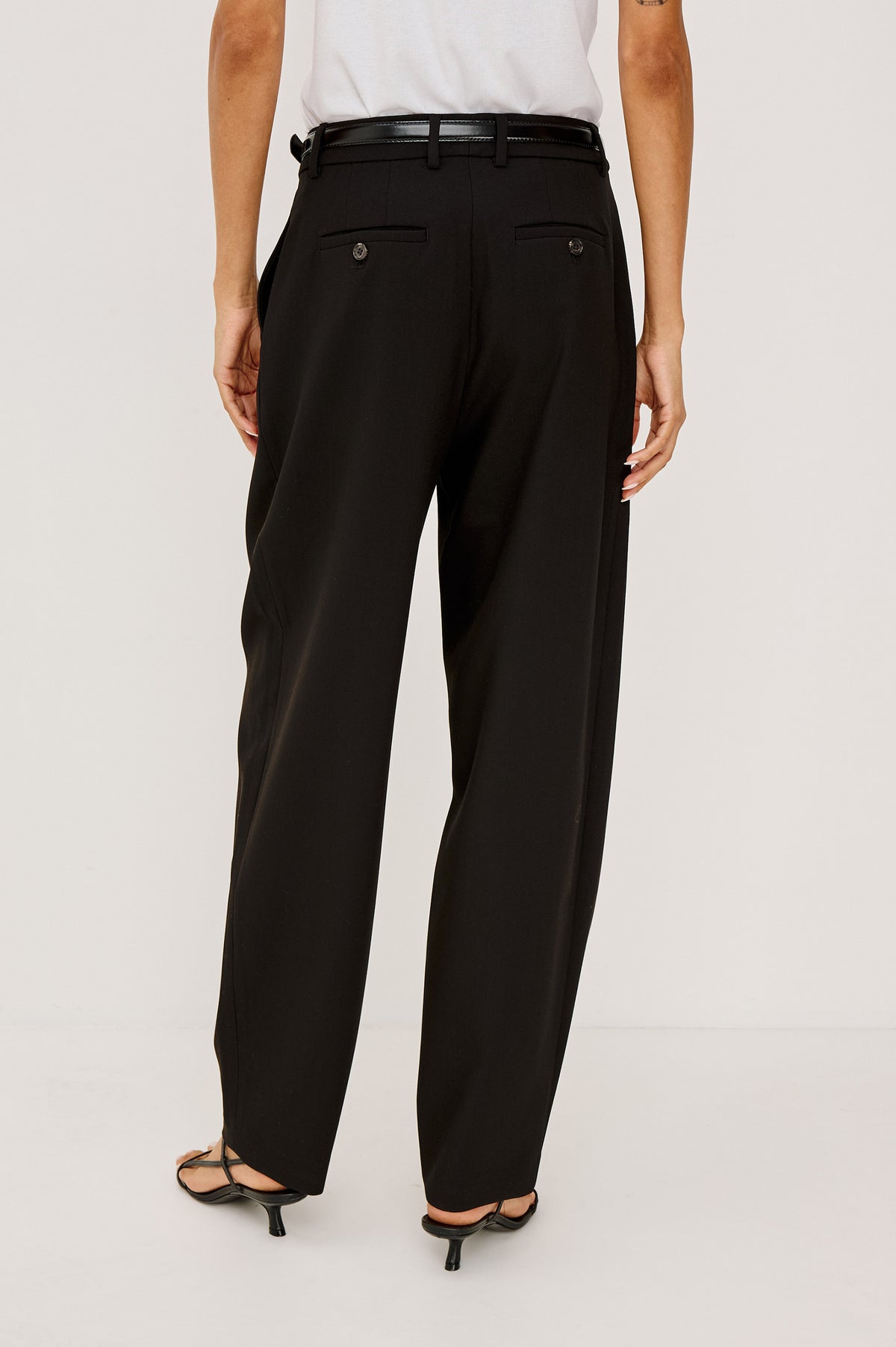 Cameron Pant in Springy Suiting Fabric With High-Rise, Pleated Barrel Legs That Taper, Side and Back Pockets, and Unlined in Black Colorway - Lower Body Back View Featured on Model