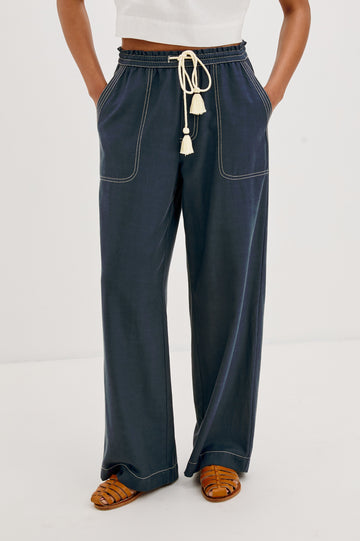 Campo Wide Leg Pant with Drawstring Waistband, Front Utility Patch Pockets and Contrast White Stitching in Navy Colorway. Front View Shown on Model.