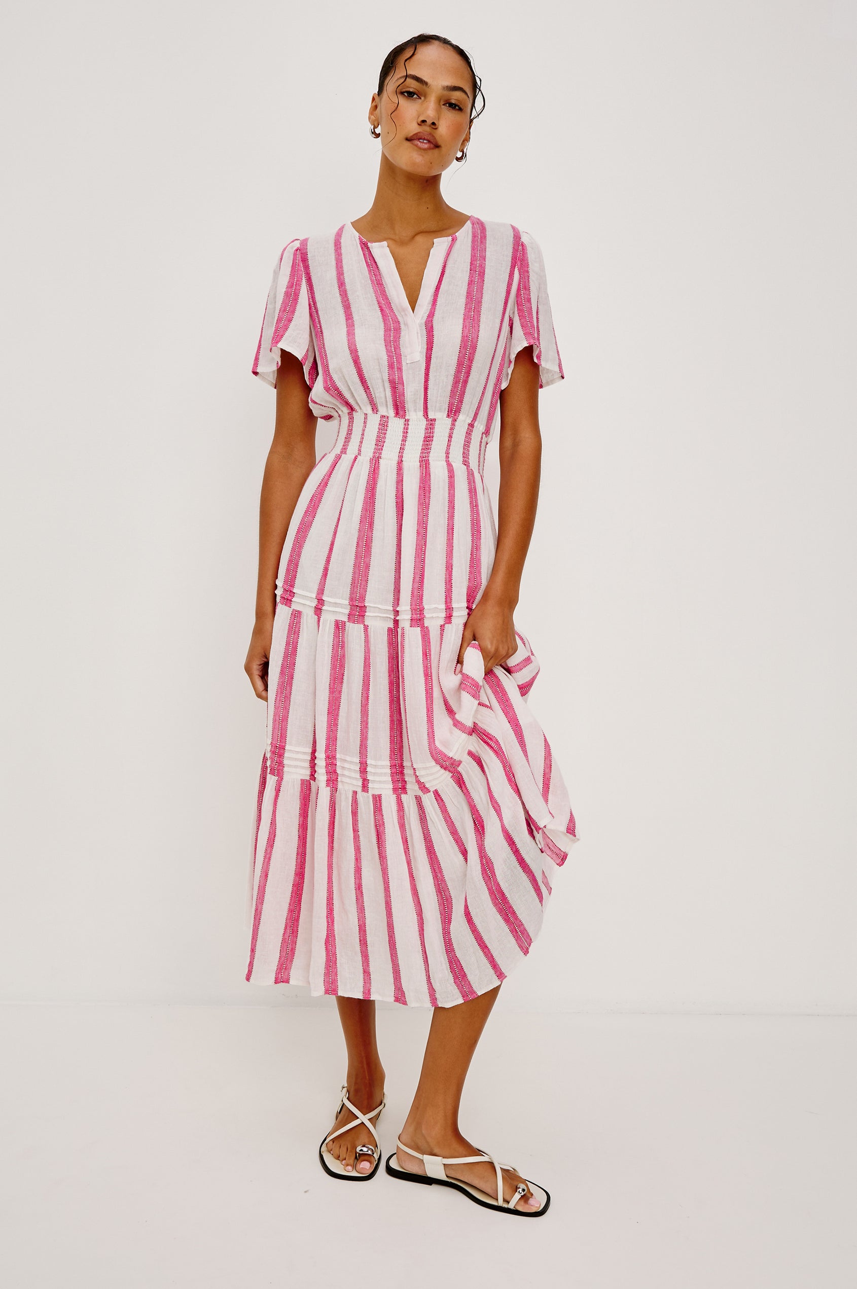 Cannes Short-Sleeve Midi Dress with a Shirred Waist, Tiered Skirt and Short Slit at Neck in Lake View Stripe Colorway, vertical stripes in blues and white - Front Full Body View Featured on Model