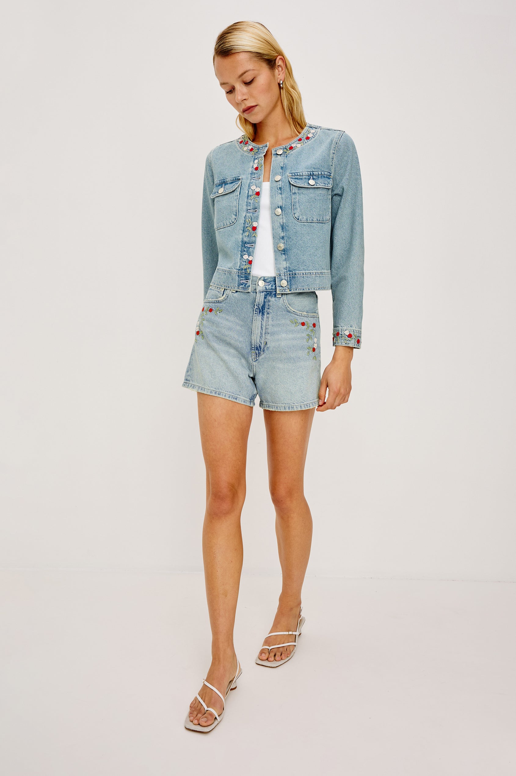 Capistrano Lady Jacket in Recycled Cotton Denim Blend With Floral Embroidery, Chest Flap Buttoned Pockets, and Long Sleeves in Dainty Rose Colorway - Front View Featured on Model