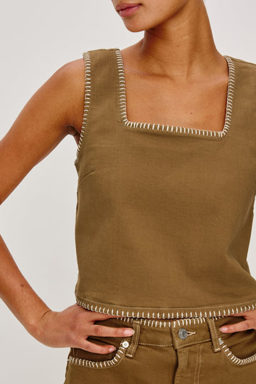 Carbon Denim Tank Top with Wide Straps, Square Neckline and Blanket Stitching on Edges in Safari Embroidered Colorway. Front Detail View on Model Shown.