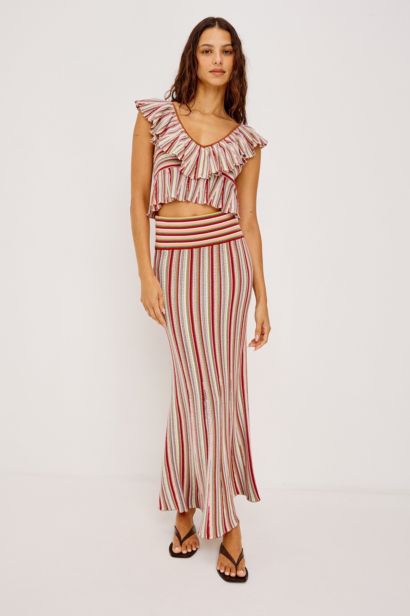 Carmelita Crop Top in Crochet Knit With Ruffle V-Neckline, Fitted Bodice, and Peplum Hem in Havana Stripe Colorway - Full Body Front View Featured on Model