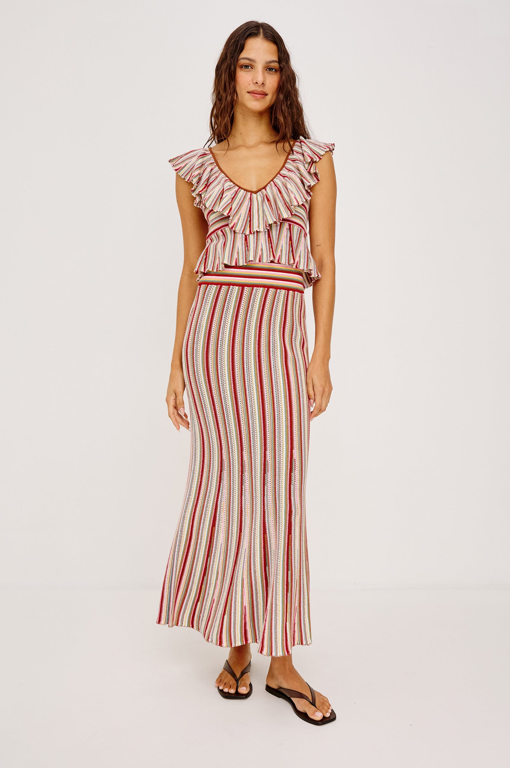 Carmelita Crop Top in Crochet Knit With Ruffle V-Neckline, Fitted Bodice, and Peplum Hem in Havana Stripe Colorway - Full Body Front View Featured on Model
