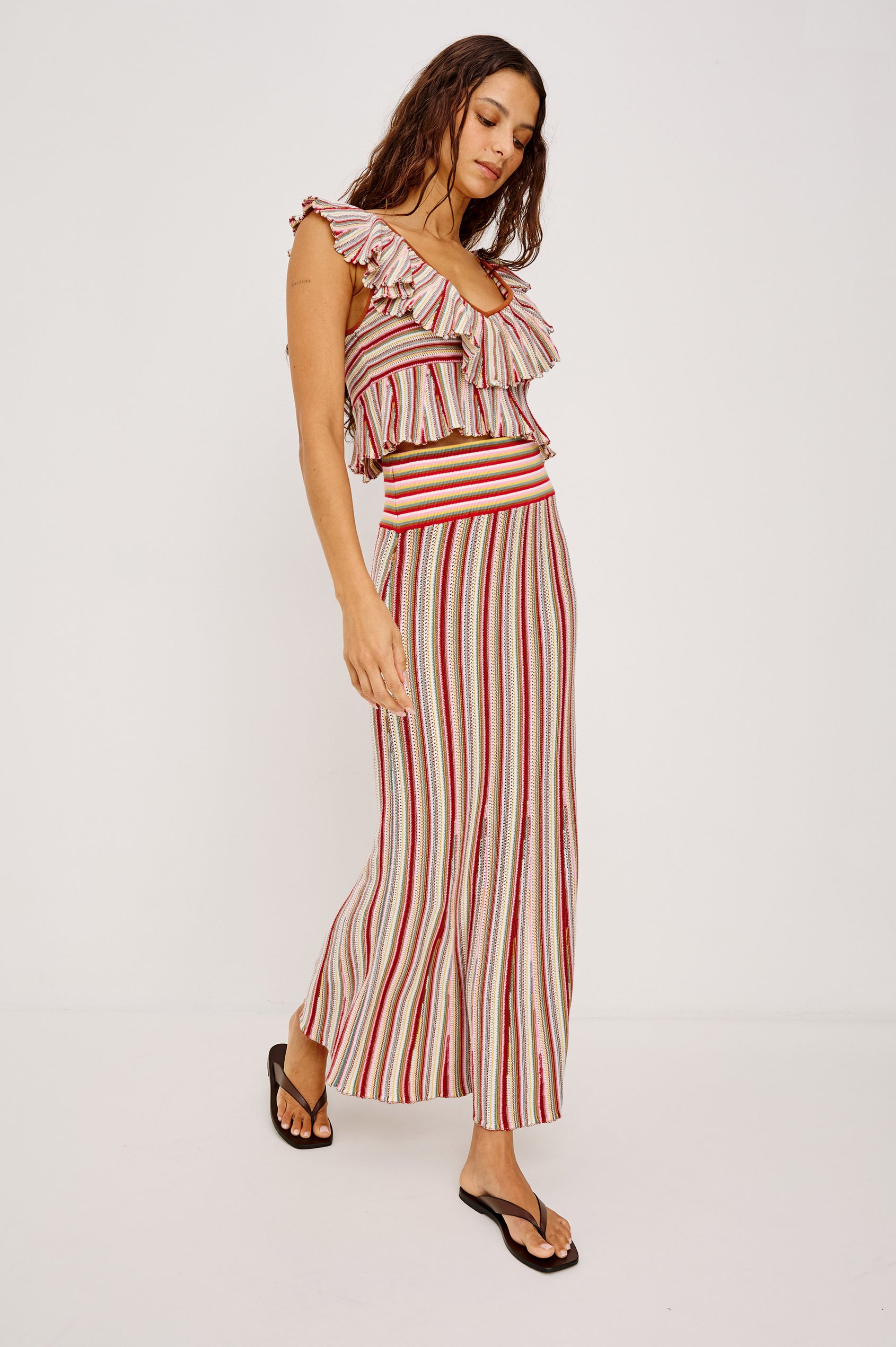 Carmelita Crop Top in Crochet Knit With Ruffle V-Neckline, Fitted Bodice, and Peplum Hem in Havana Stripe Colorway - Full Body Front View Featured on Model