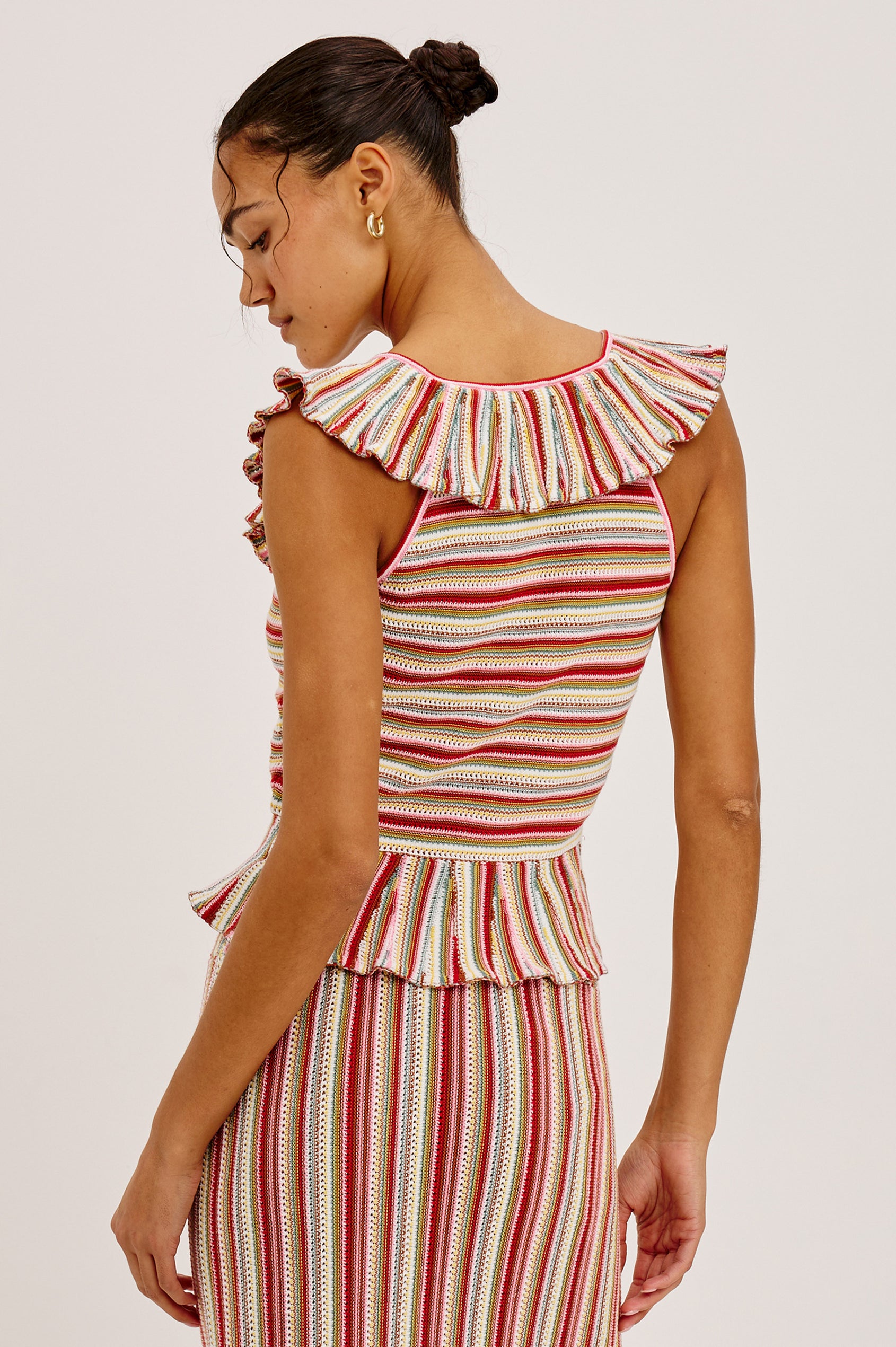 Carmelita Crop Top in Crochet Knit With Ruffle V-Neckline, Fitted Bodice, and Peplum Hem in Havana Stripe Colorway - Upper Body Back View Featured on Model