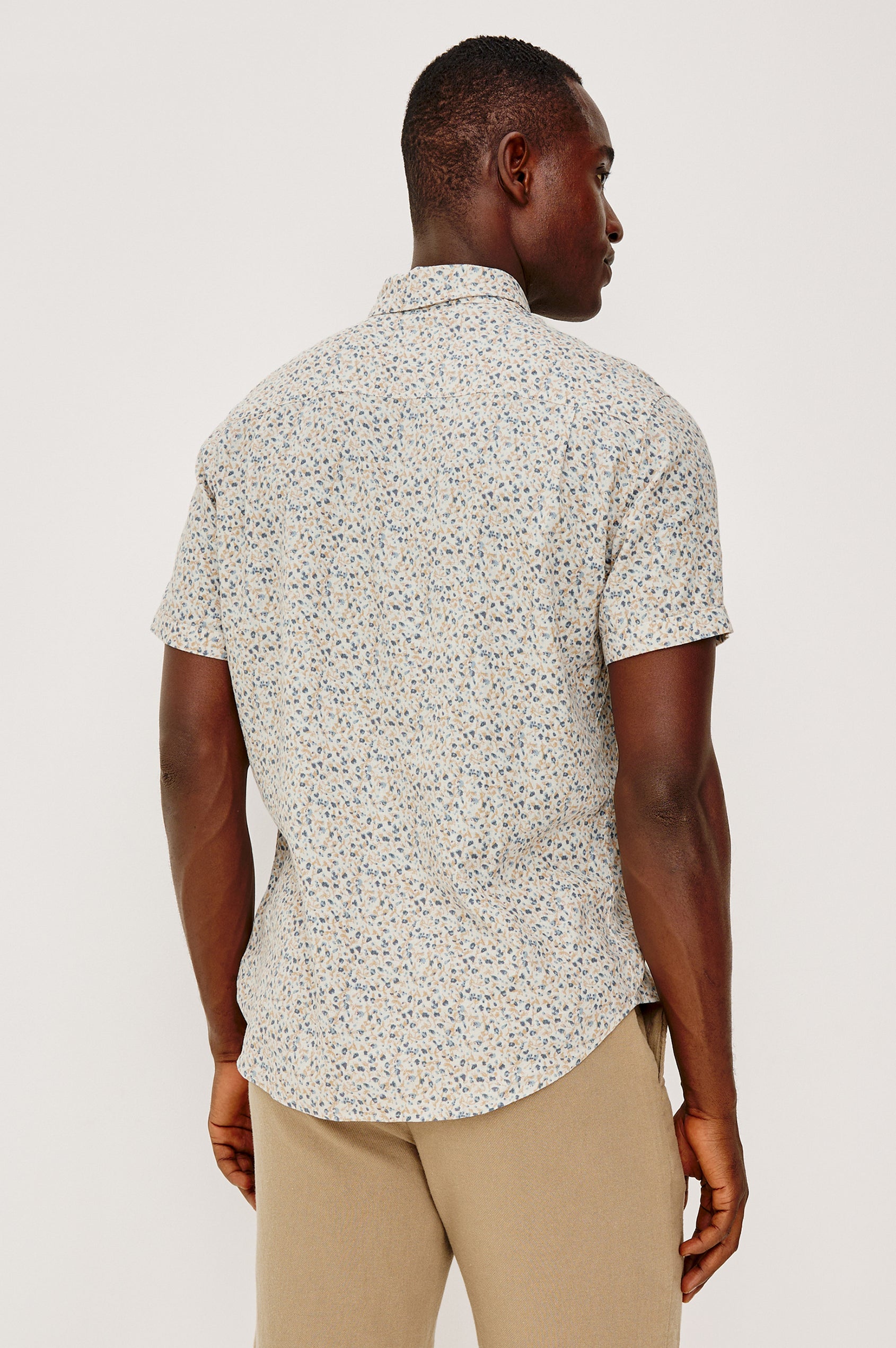 Carson Button Front Shirt in Linen Blend With Collar, Short Sleeves, Chest Patch Pocket, and Classic Fit in Spring Blossom Parchment Colorway - Upper Body Back View Featured on Model