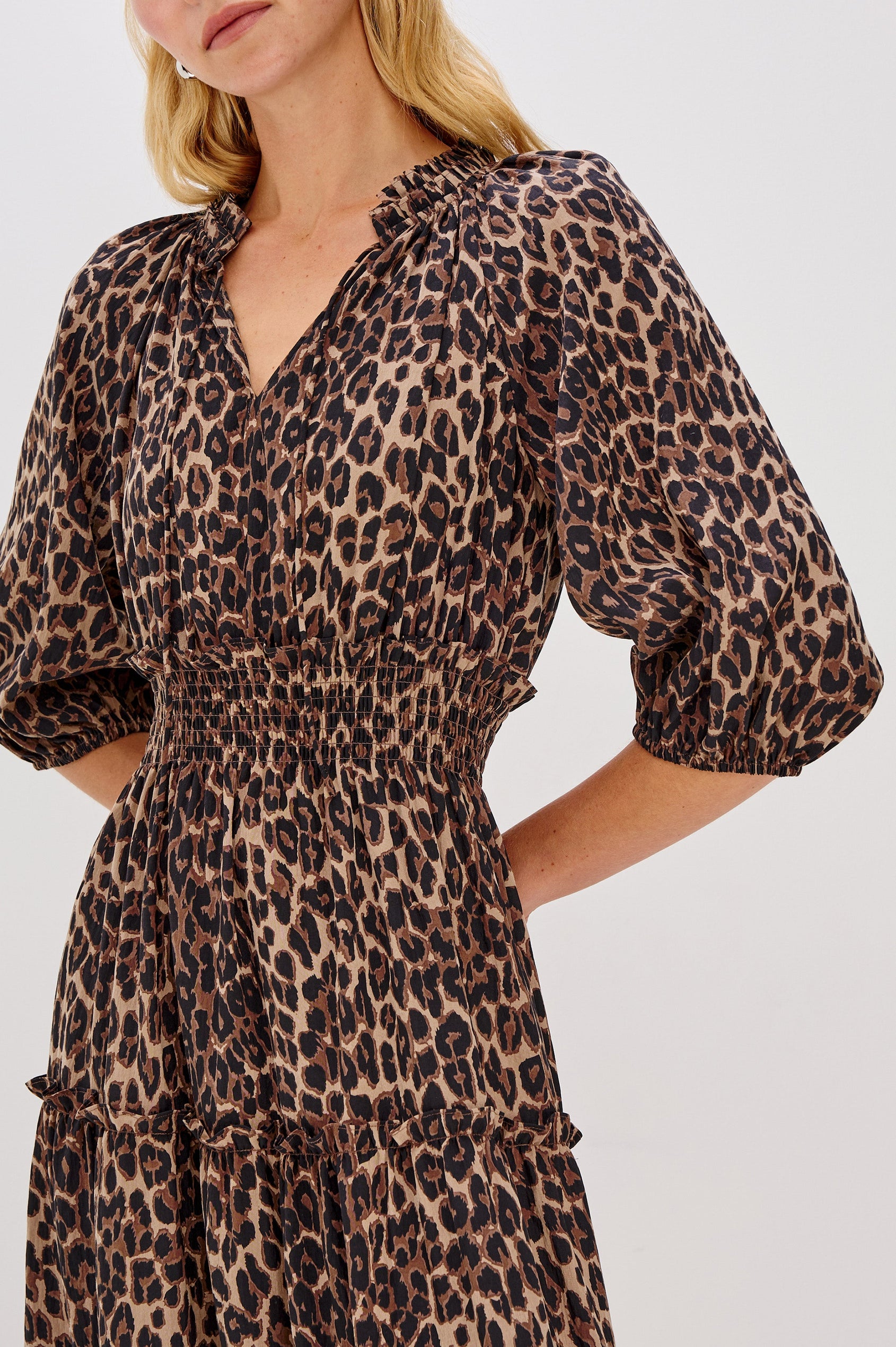 Caterine Maxi Dress with Mid-length Sleeves, a V neck, a Shirred Collar with a tie, a Smocked Waist, and a Tiered Skirt in Brown Nala Colorway - Close up of Details on Model