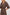 Caterine Maxi Dress with Mid-length Sleeves, a V neck, a Shirred Collar with a tie, a Smocked Waist, and a Tiered Skirt in Brown Nala Colorway - Close up of Details on Model