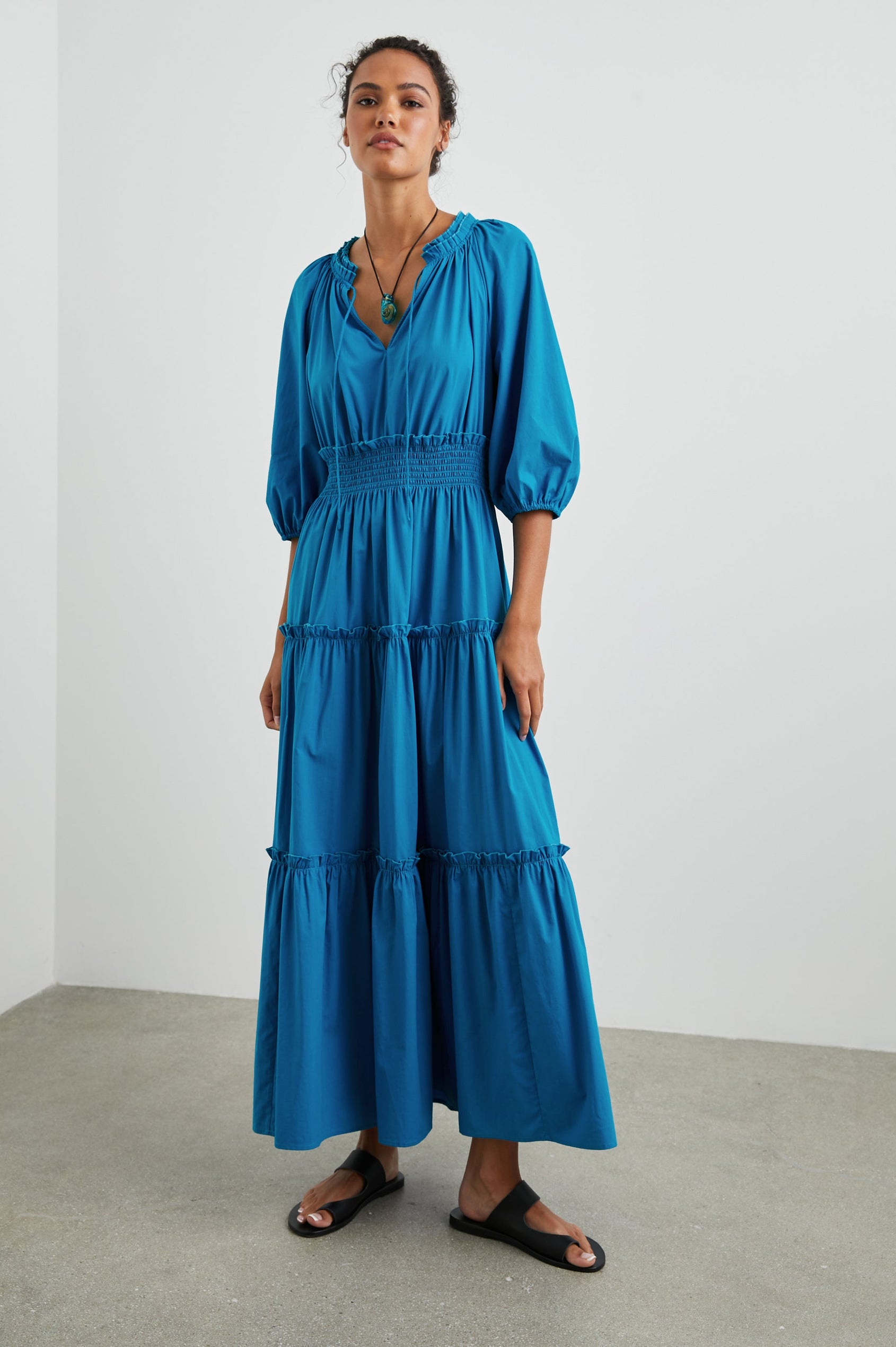 Caterine Maxi Dress with Mid-length Sleeves, a V neck, a Shirred Collar with a tie, a Smocked Waist, and a Tiered Skirt in Turkish Tile Colorway, a blue - Front Full Body View Featured on Model