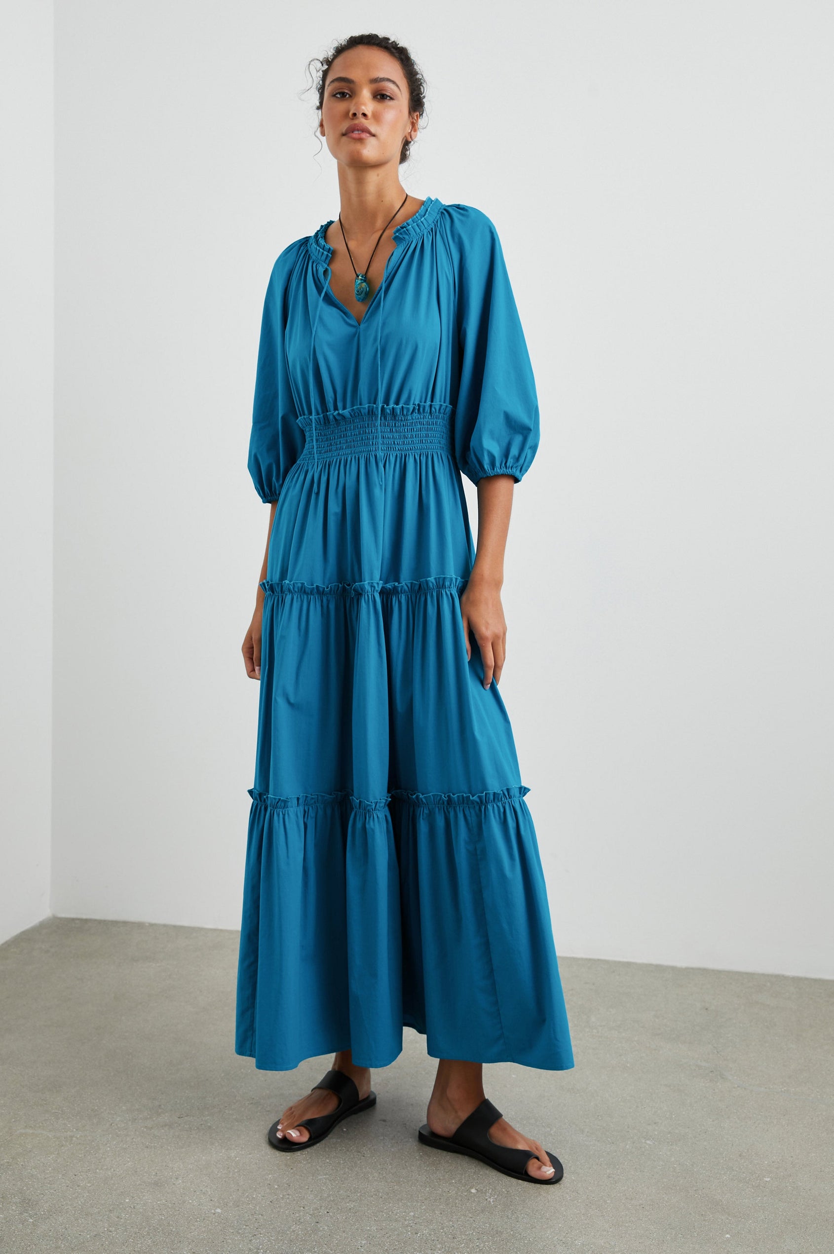 Caterine Maxi Dress with Mid-length Sleeves, a V neck, a Shirred Collar with a tie, a Smocked Waist, and a Tiered Skirt in Turkish Tile Colorway, a blue - Front Full Body View Featured on Model