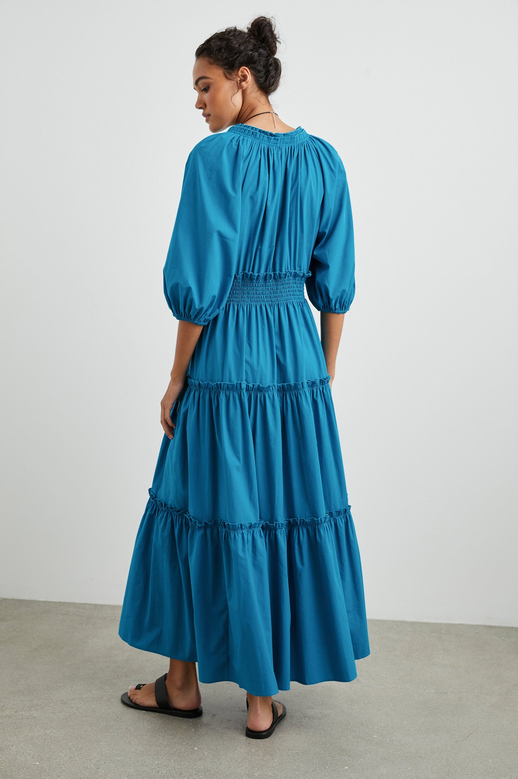 Caterine Maxi Dress with Mid-length Sleeves, a V neck, a Shirred Collar with a tie, a Smocked Waist, and a Tiered Skirt in Turkish Tile Colorway, a blue - Back Full Body View Featured on Model