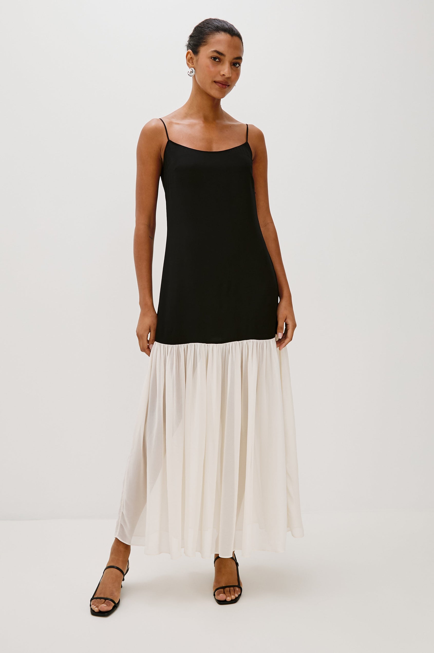 Chandra Maxi Tank Dress with Spaghetti Straps and a Contrast Semi Sheer Fabric Gathered Hem in Black Ivory Colorway - full body front view on model