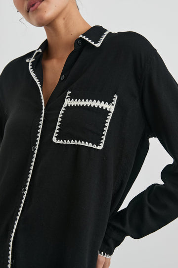 Charli Long-Sleeve Button up with a Chest Patch Pocket in Black Blanket Stitch Colorway, with white blanket stitches on black - Front View Featured on Model