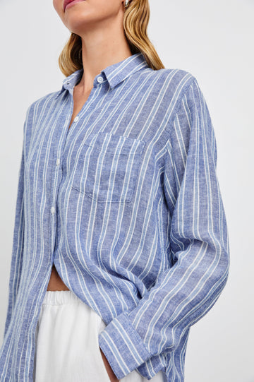 Charli Long-Sleeve Button up with a Chest Patch Pocket in Lake View Stripe Colorway, with alternating light blue and blue stripes, each bordered by white stripes - Front View Featured on Model