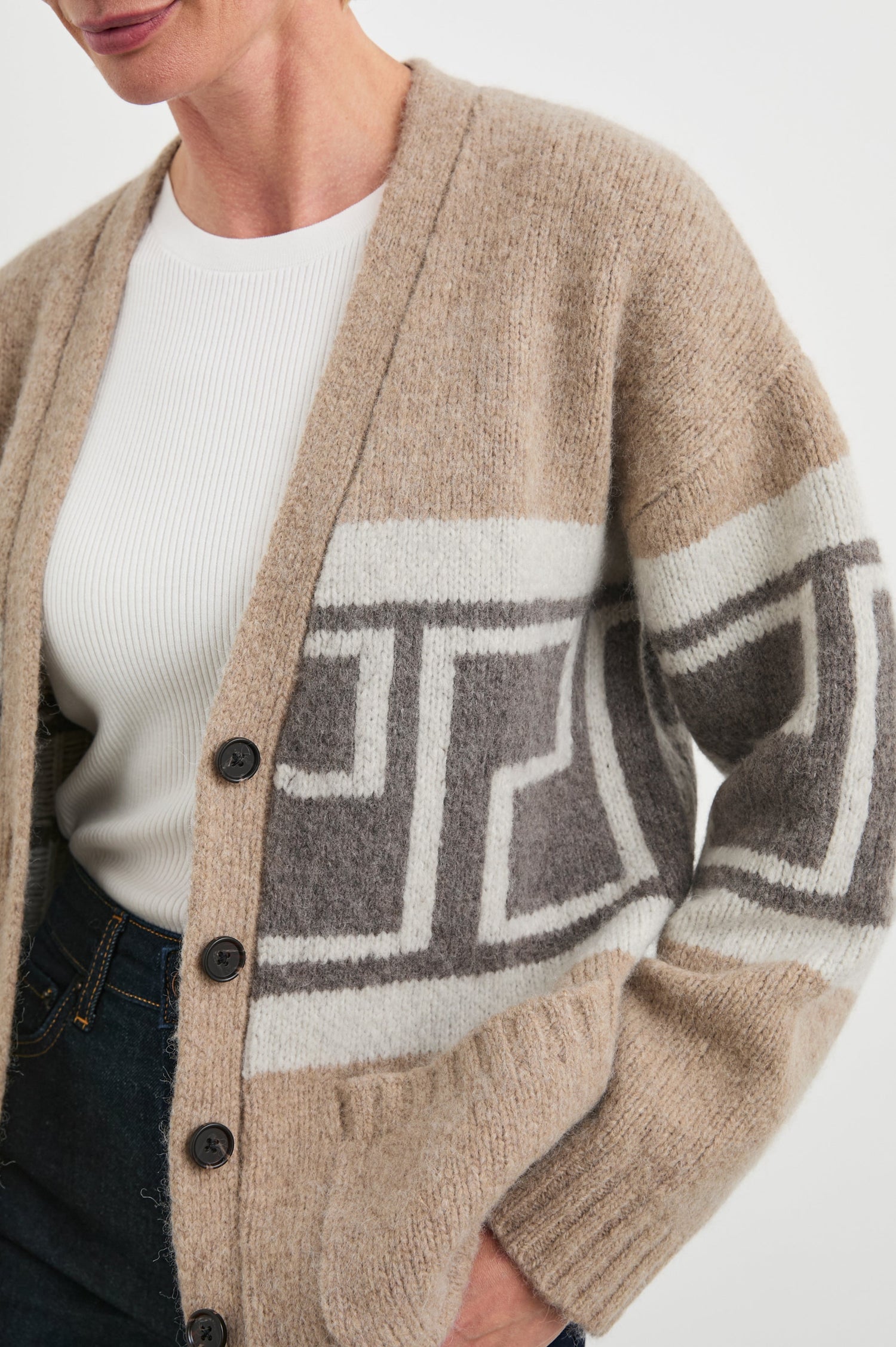 Chelsea Long-Sleeve Cardigan with Button Closure, Two Front Patch Pockets, Ribbed Trim and a Deep V Neck in Aspen Trail Colorway, a Grey and White Geometric Pattern on Oatmeal - Front Unbuttoned View Featured on Model